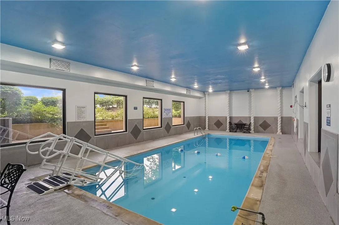 Indoor community pool featuring a sauna