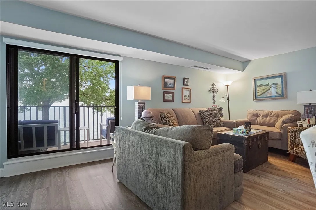 Living room featuring lvt wood plank floors and view of lake