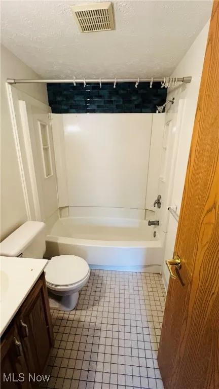 Bathroom featuring tile patterned floors, bathing tub / shower and sink vanity