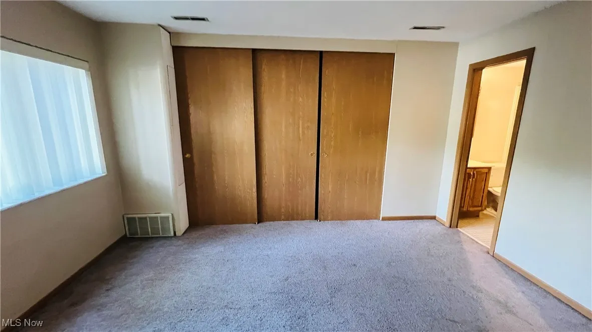 Featuring carpet floors and a closet