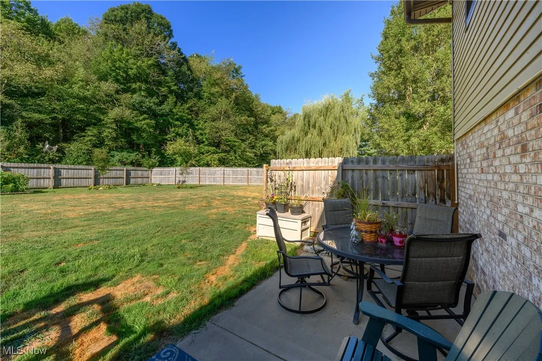 Fenced backyard featuring a patio area and outdoor dining area