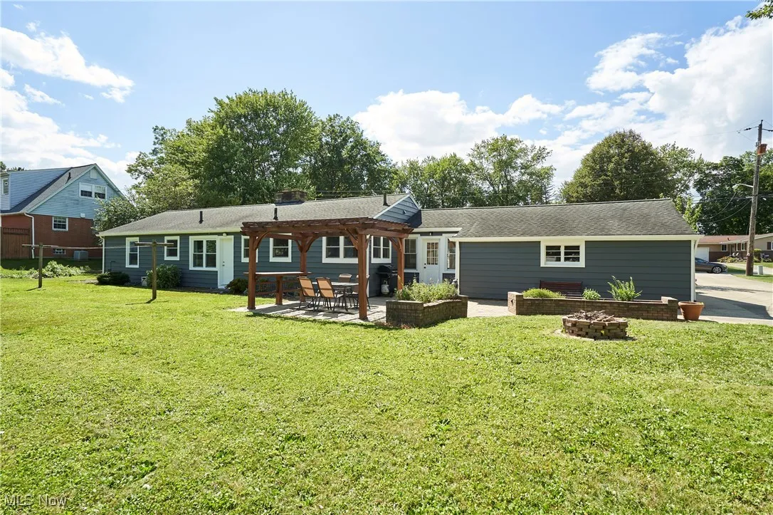 large backyard includes raised garden beds and a fire pit