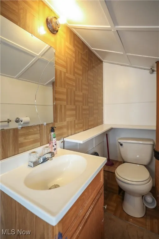 1/2 Bathroom featuring vanity and toilet