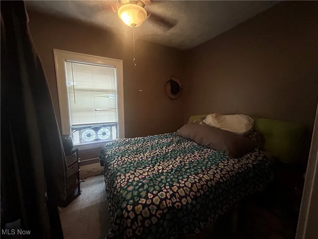 Bedroom with a ceiling fan and carpet floors