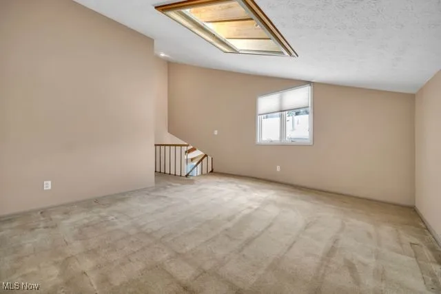 Loft area with multiple purpose can be office/den/study.. Vaulted ceiling and skylight