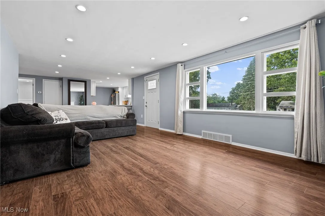Living room featuring recessed lighting and dark wood-style floors
