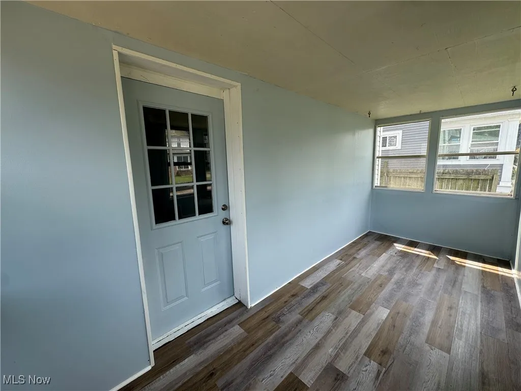 Empty room featuring dark wood-style flooring