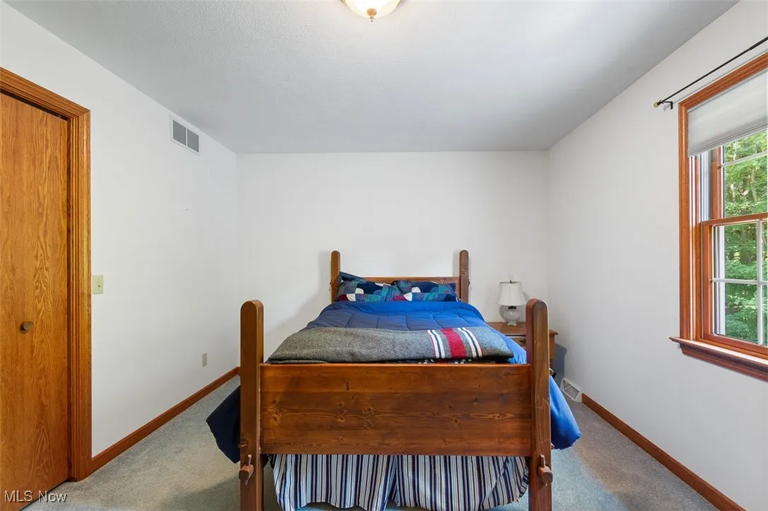 Carpeted bedroom featuring baseboards