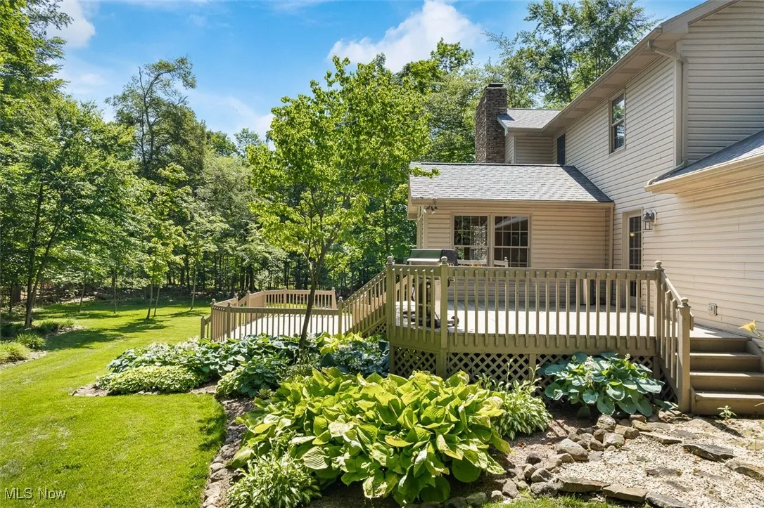 Wooden terrace featuring a yard