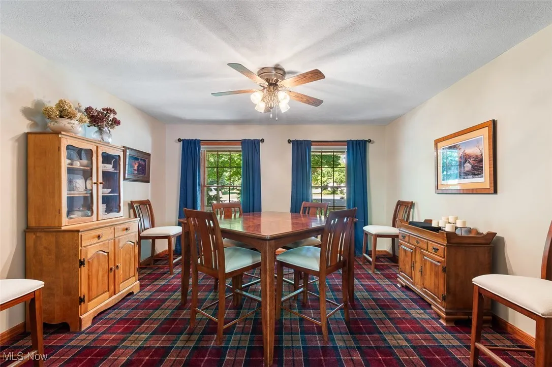 Dining space featuring a textured ceiling and a ceiling fan