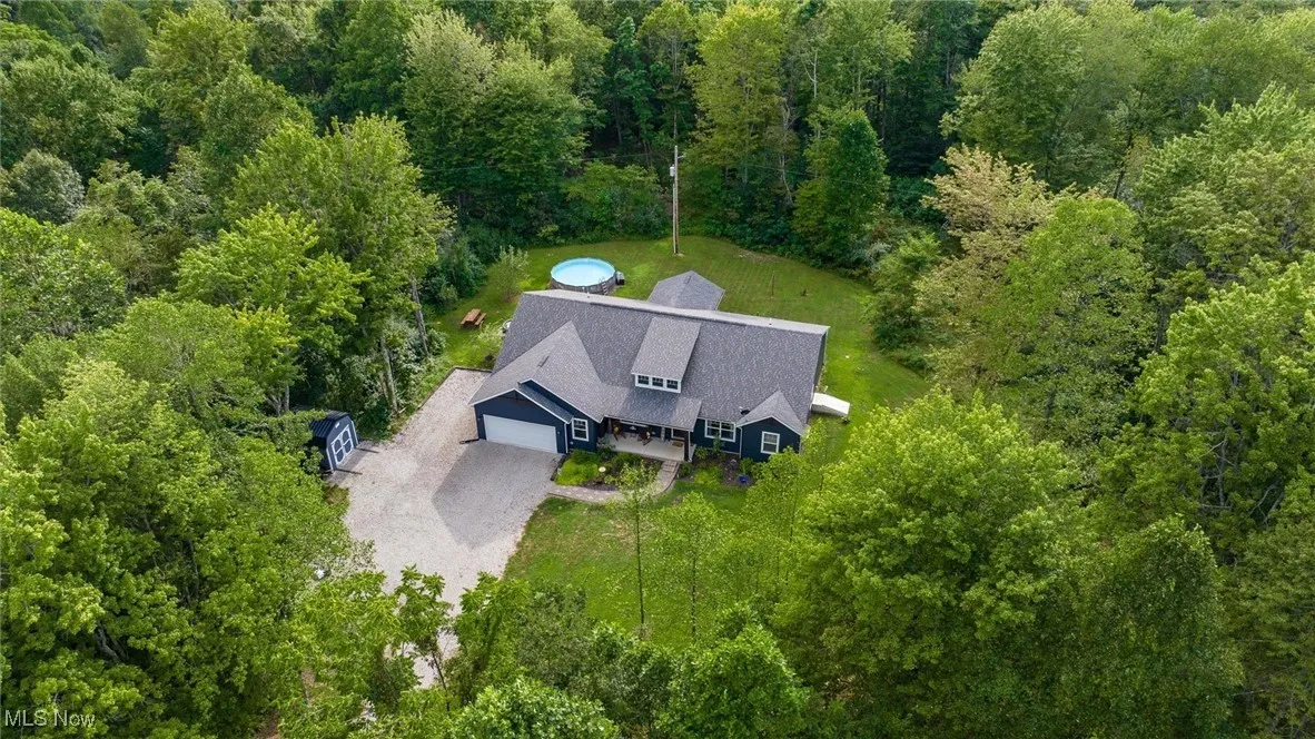 View of subject property featuring a forest