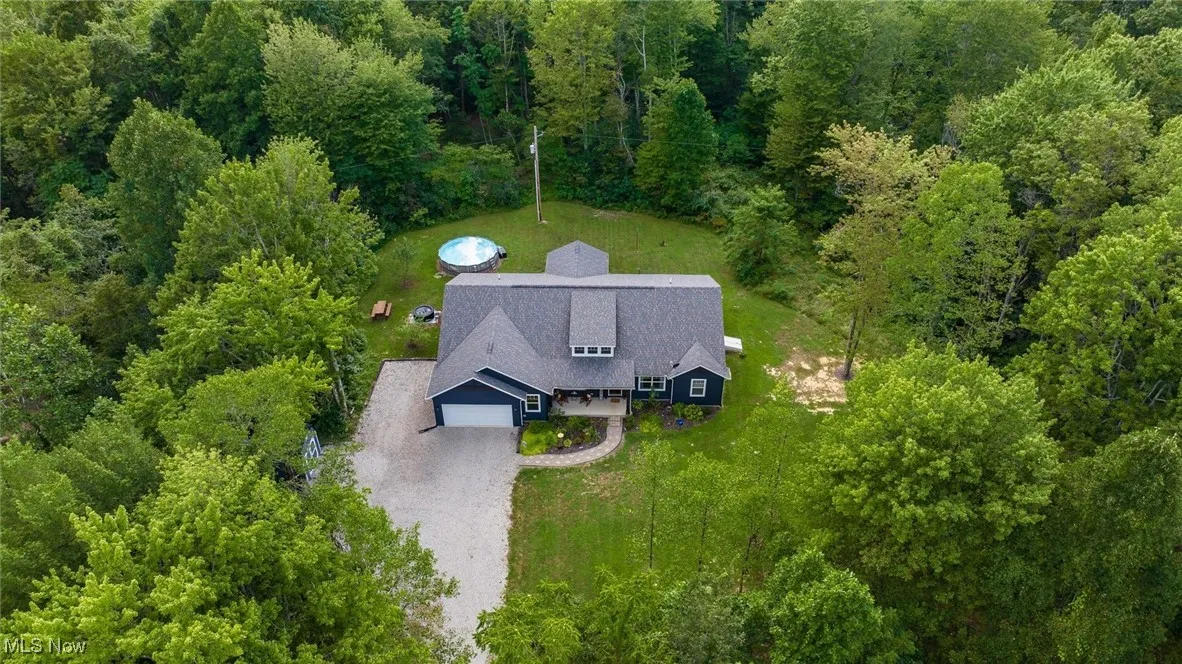View of subject property with a forest