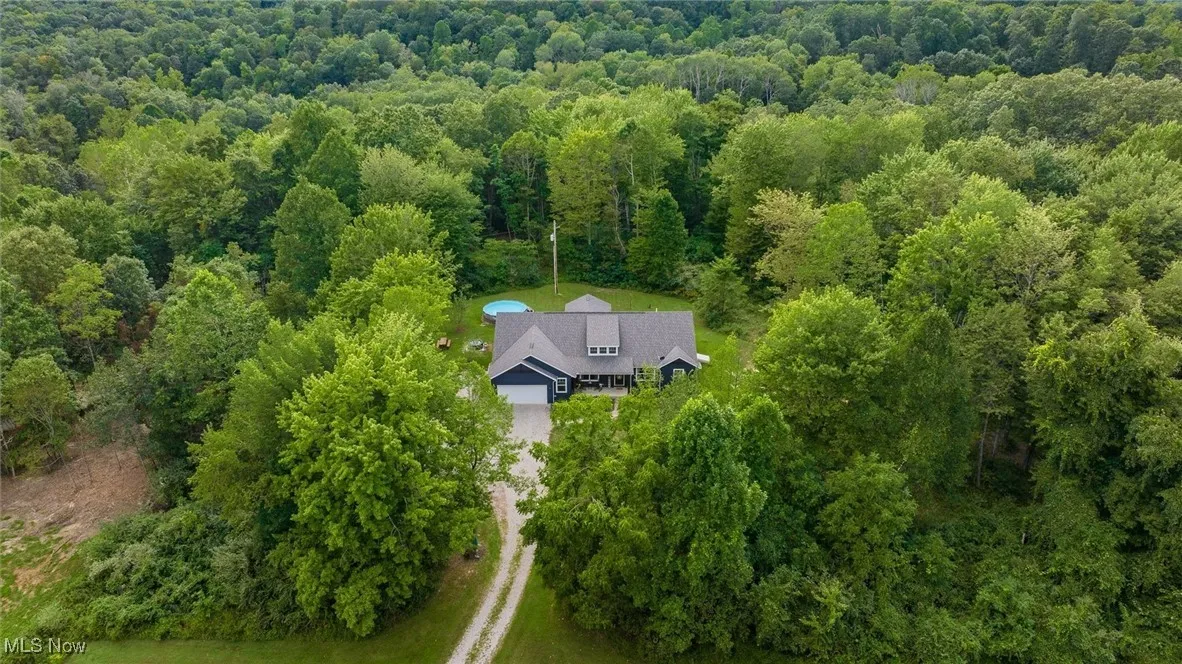 View from above of property with a forest