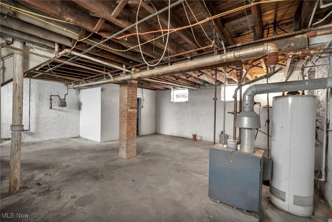 Below grade area featuring water heater