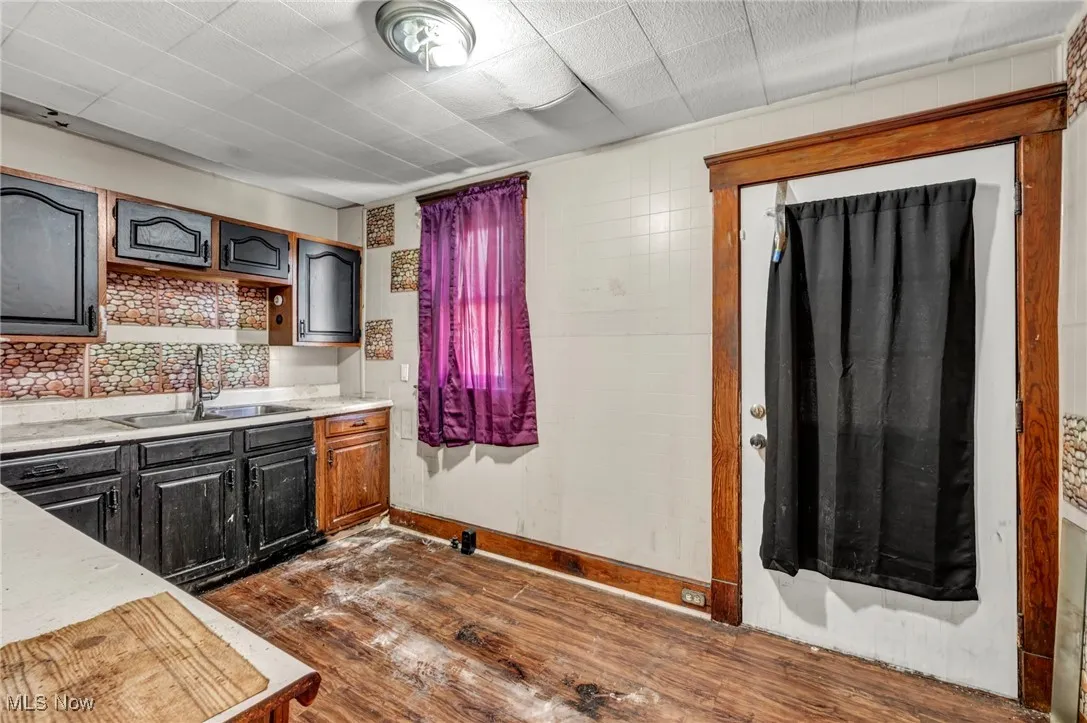 Kitchen featuring dark wood-style flooring and light countertops