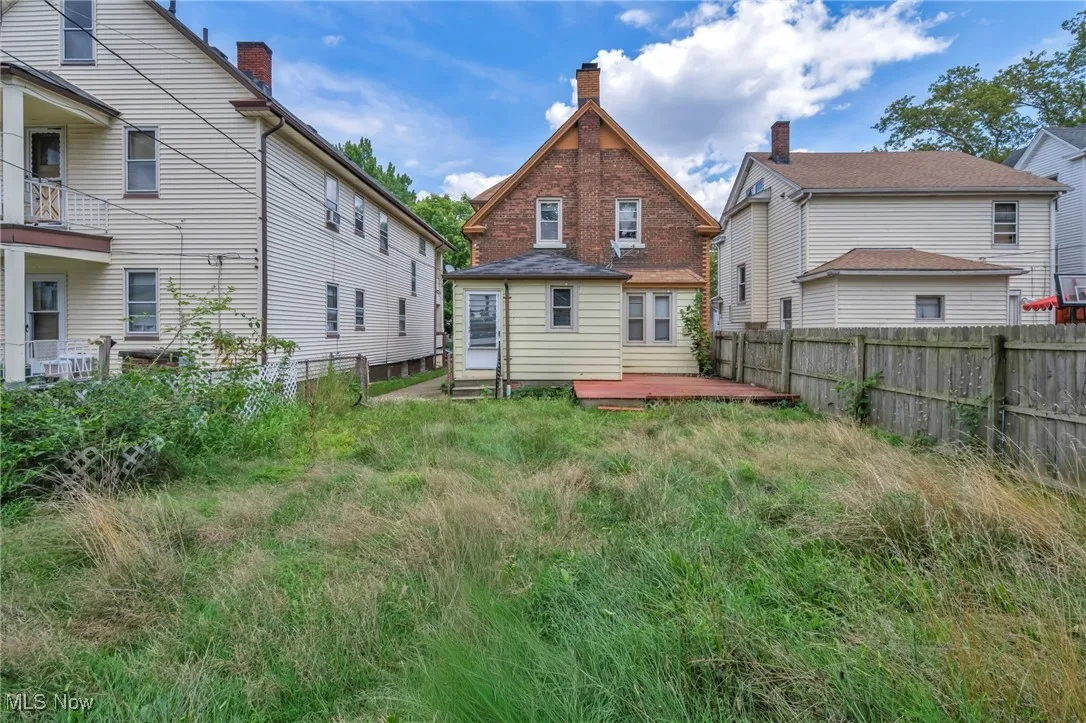 Back of house with a fenced backyard