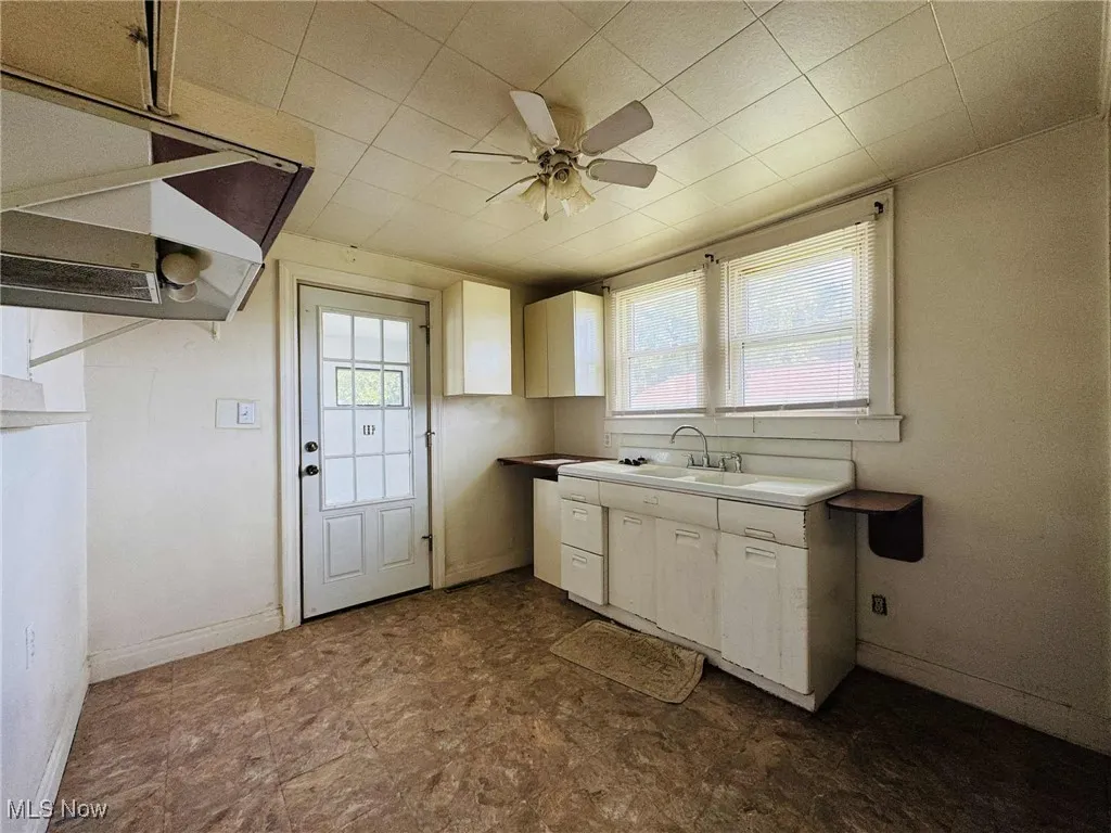 Kitchen featuring white cabinetry, a ceiling fan, and light countertops