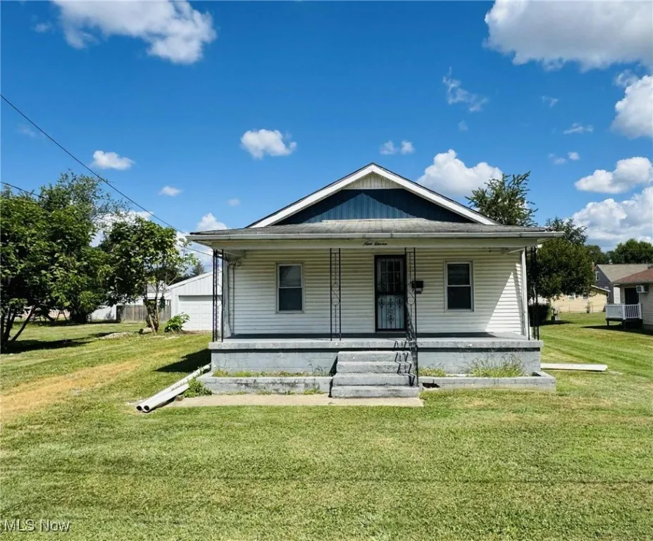 Bungalow-style house with a porch and a front yard