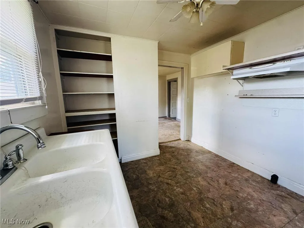 Bathroom with built in features and ceiling fan