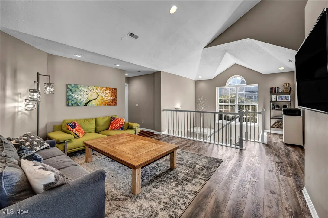 Living room, recessed lighting, and high vaulted ceiling