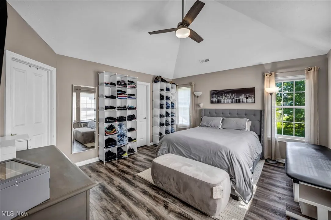 Bedroom featuring lofted ceiling, natural lighting windows, and ceiling fan