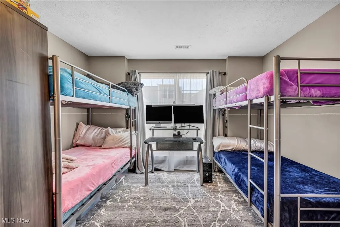 Bedroom with a textured ceiling