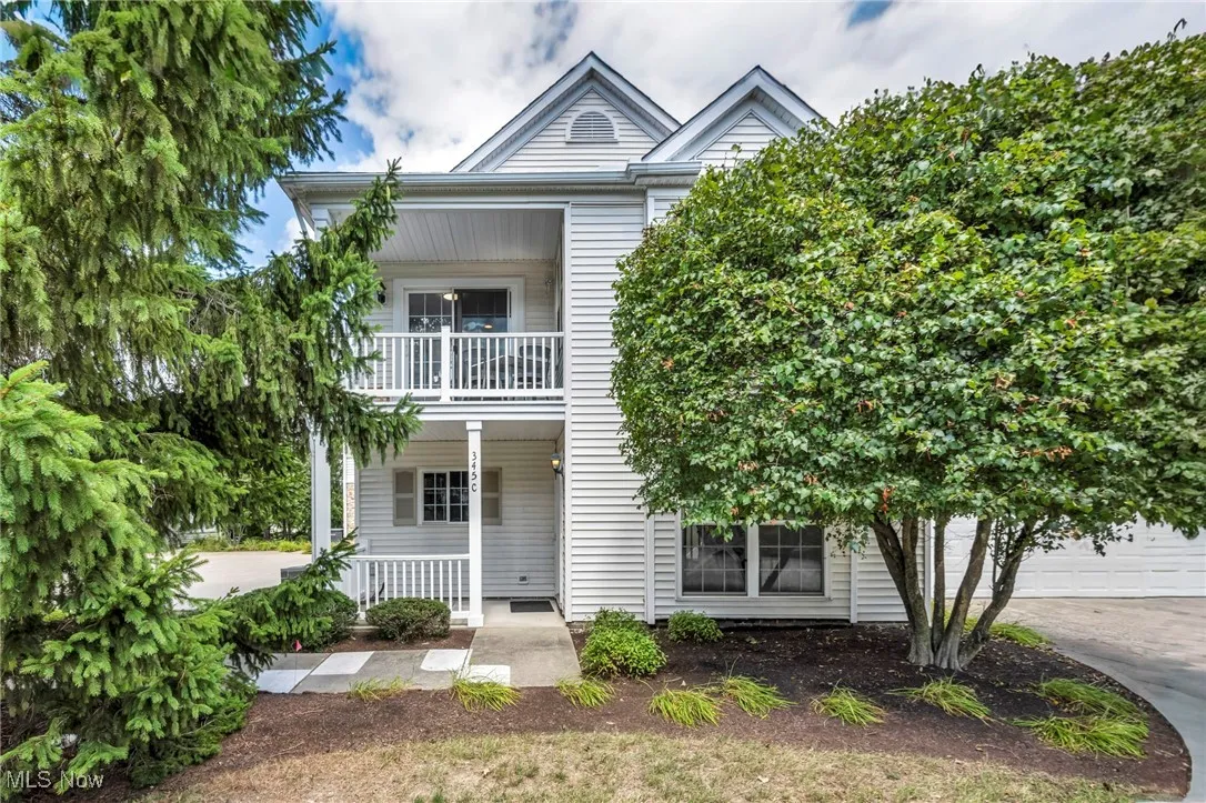 View of front of house with a porch and concrete driveway