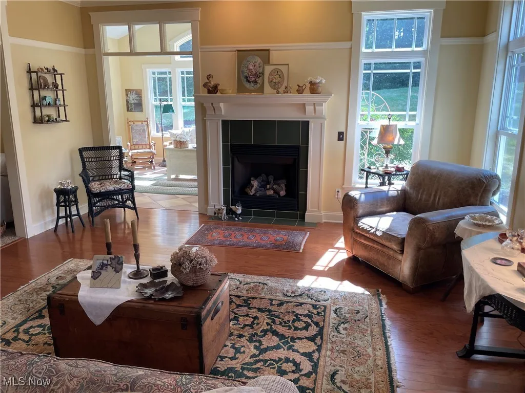 Living area featuring wood finished floors and a tile fireplace