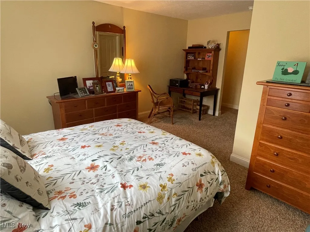 Carpeted bedroom featuring baseboards