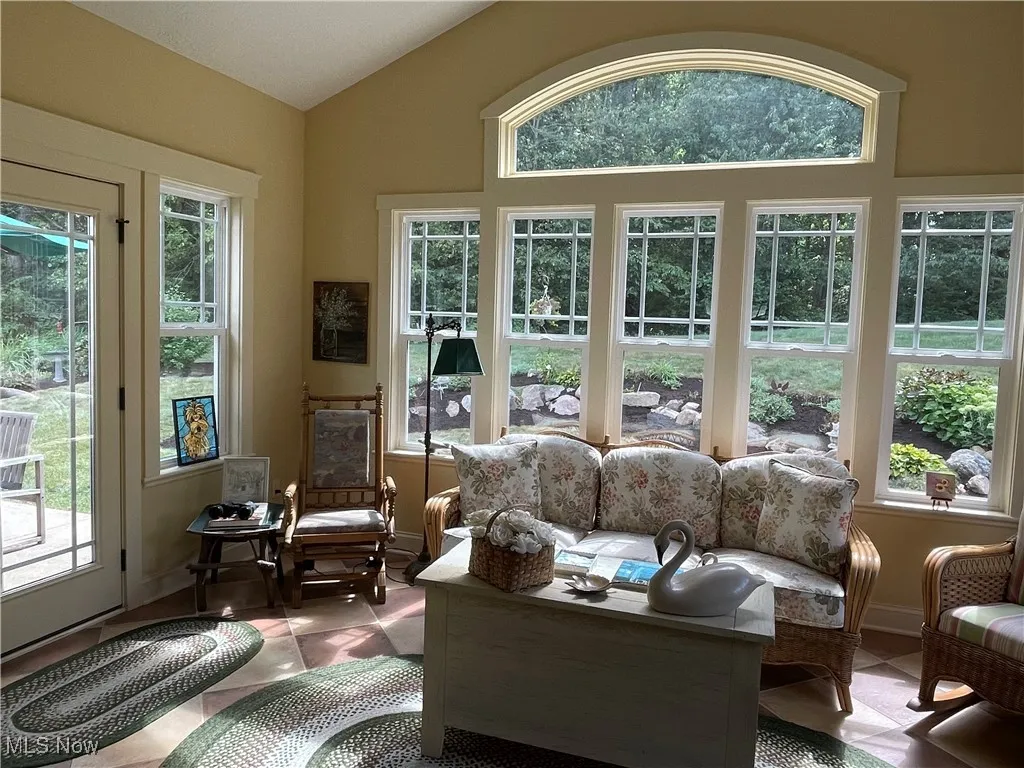Sunroom / solarium featuring vaulted ceiling and plenty of natural light