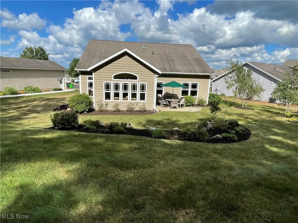 Back of property with a patio area and a yard