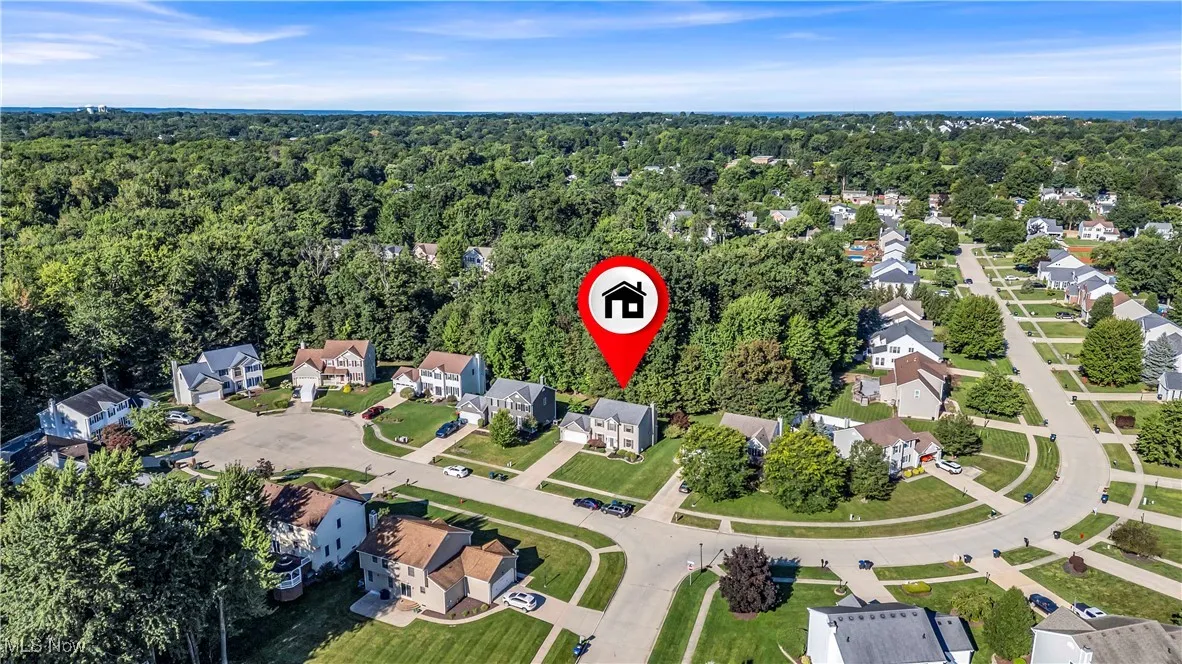 Aerial view of property's location with nearby suburban area