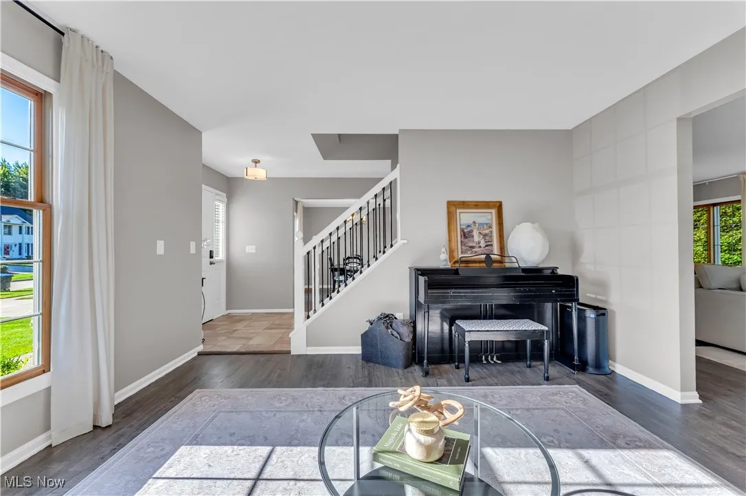 Living area with wood finished floors and stairway