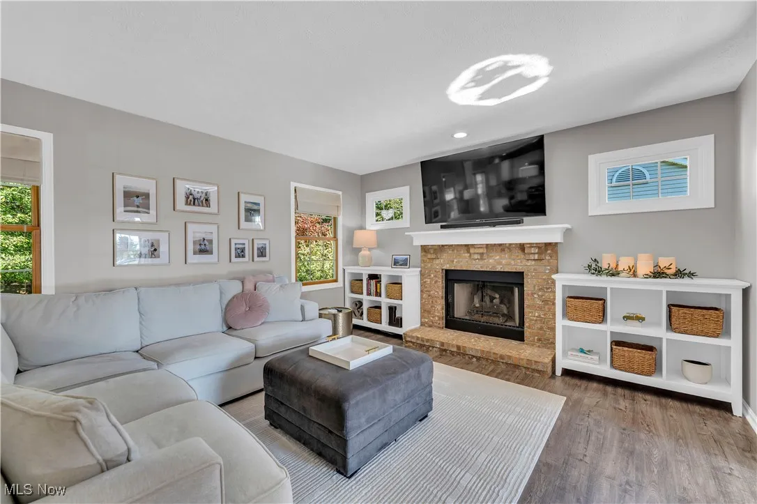 Living area featuring healthy amount of natural light, wood finished floors, and a fireplace