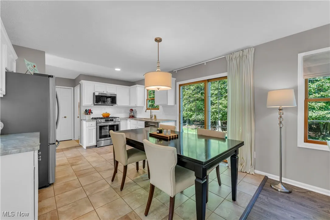 Dining area featuring light tile patterned floors and healthy amount of natural light