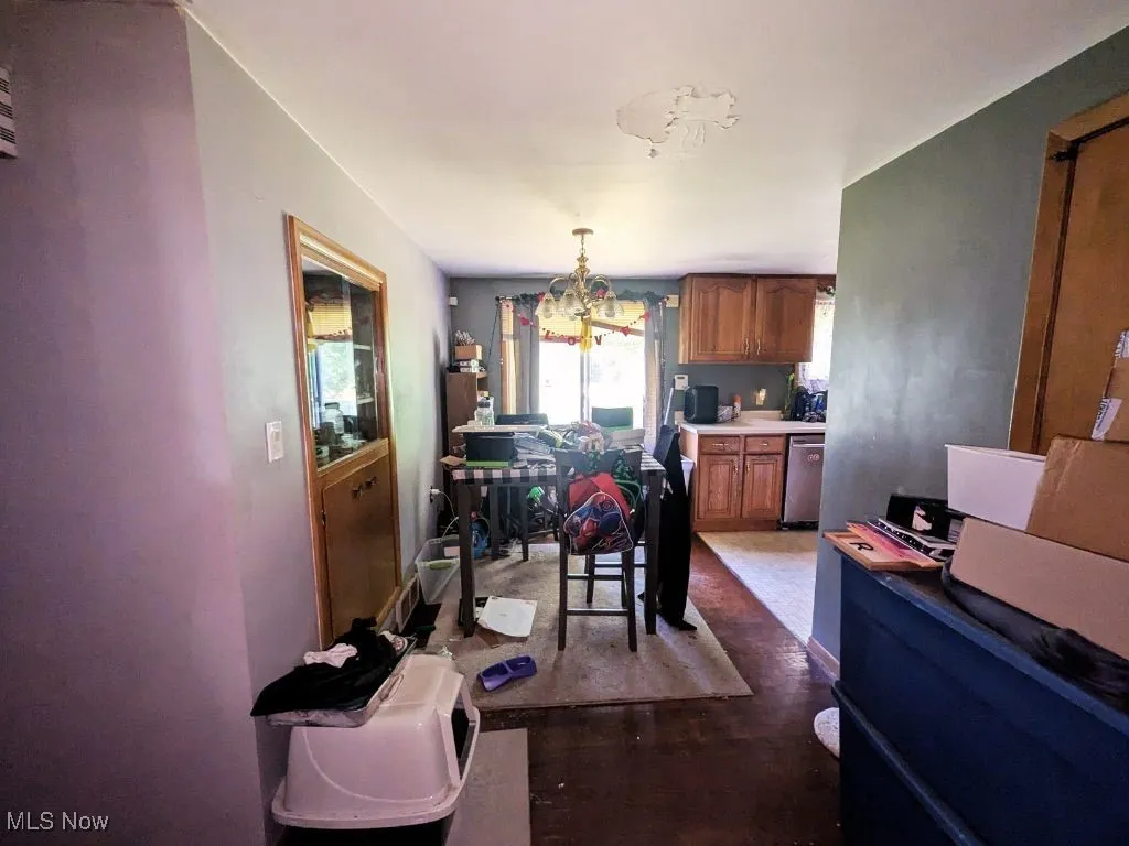 Dining area leading to kitchen and hallway to bathroom and bedrooms.