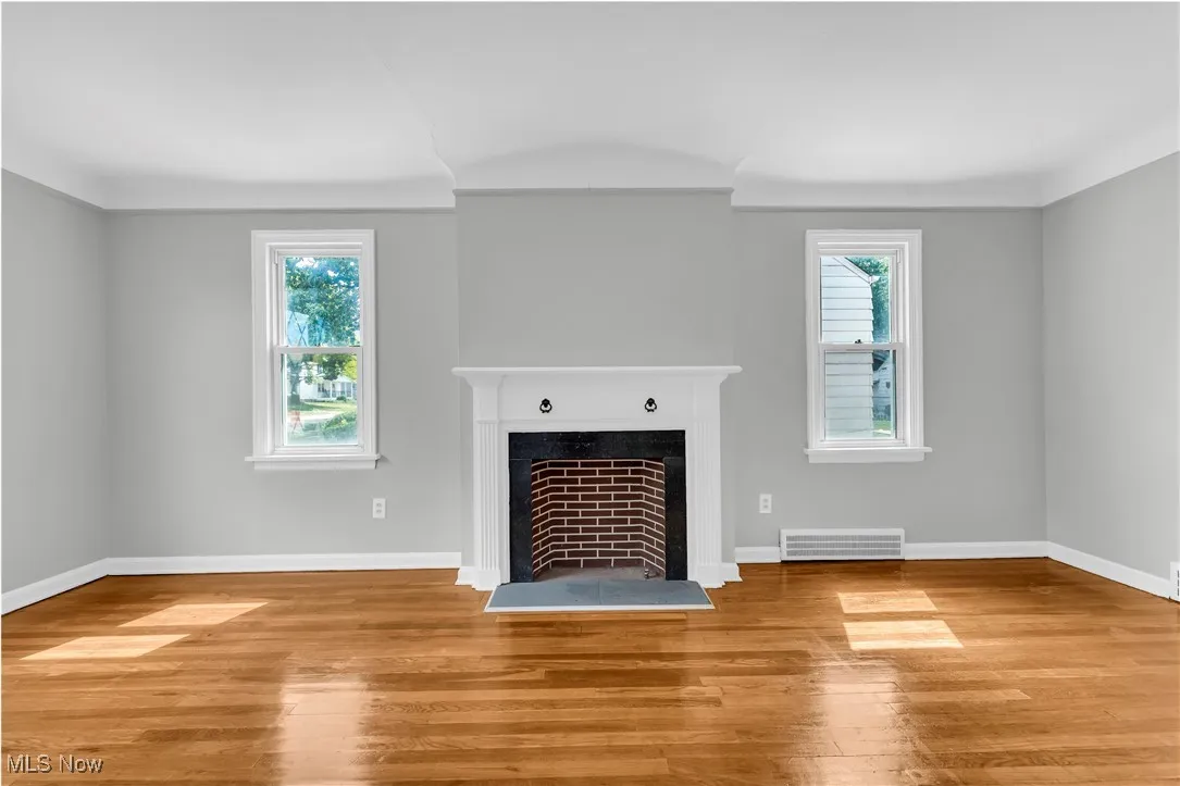 Unfurnished living room featuring a fireplace and light wood-style floors