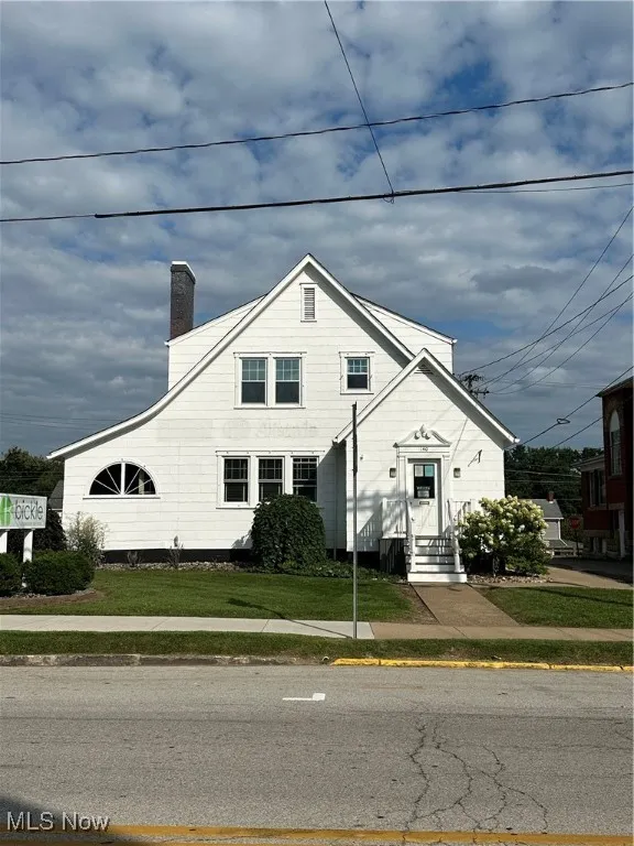 View of front of property with a chimney and a front​​‌​​​​‌​​‌‌​‌‌​​​‌‌​‌​‌​‌​​​‌​​ yard