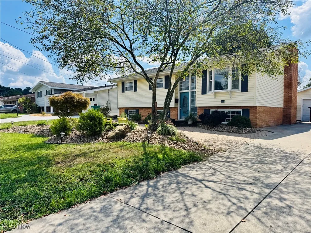 PAVED DRIVEWAY WITH SITTING PATIO OUT FRONT