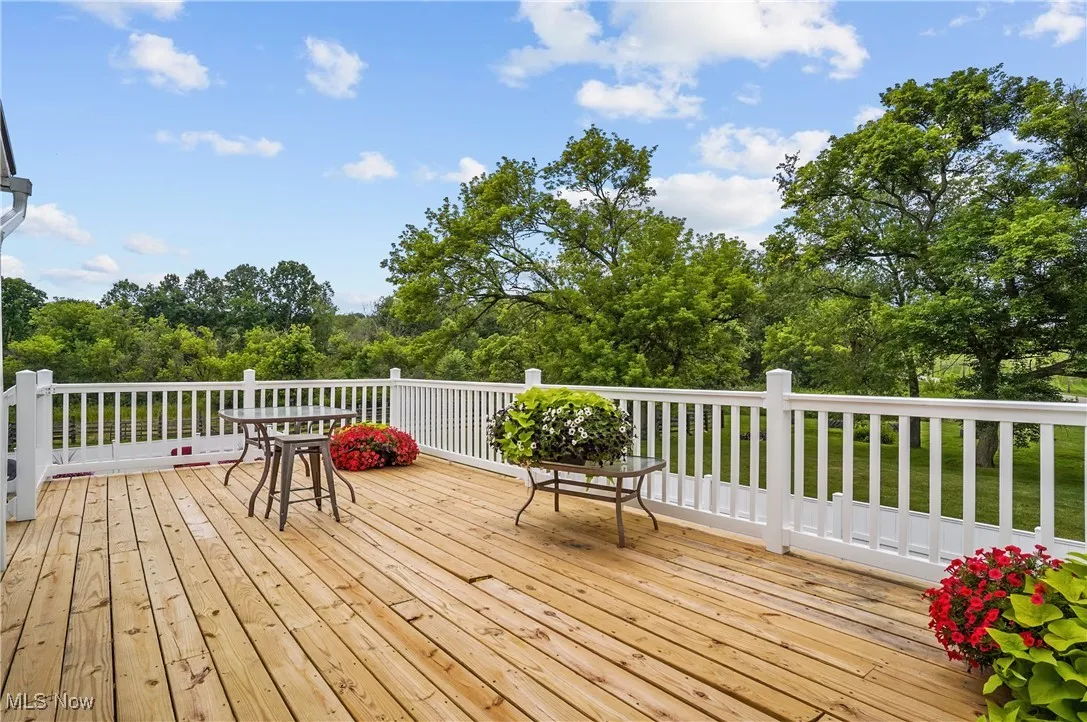 Wooden terrace featuring view of scattered trees
