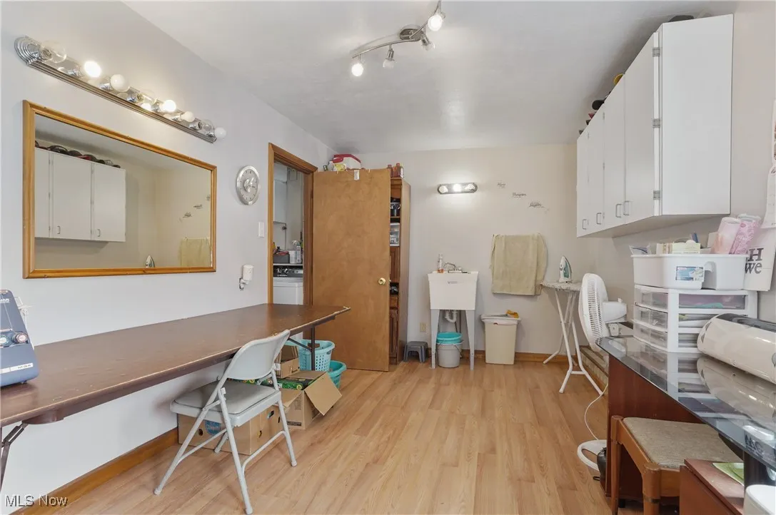 Home office with light wood-style floors and baseboards