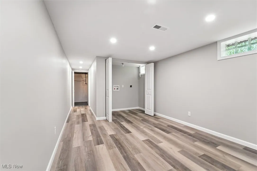 Basement featuring light wood-type flooring and recessed lighting