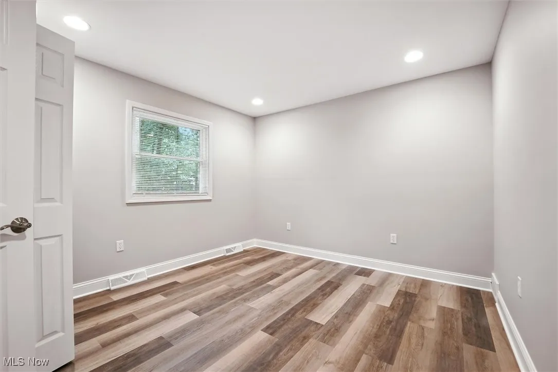 Unfurnished room with recessed lighting and light wood-type flooring