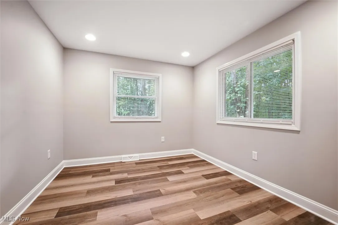 Spare room with light wood-style flooring and recessed lighting