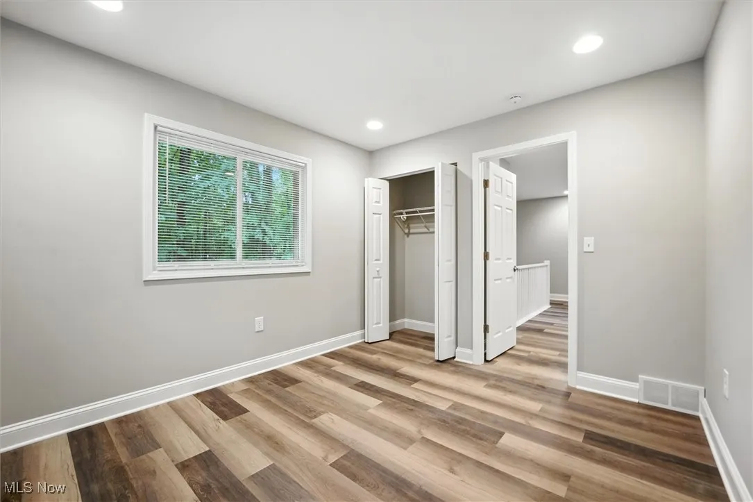 Unfurnished bedroom featuring recessed lighting, light wood-style floors, and a closet