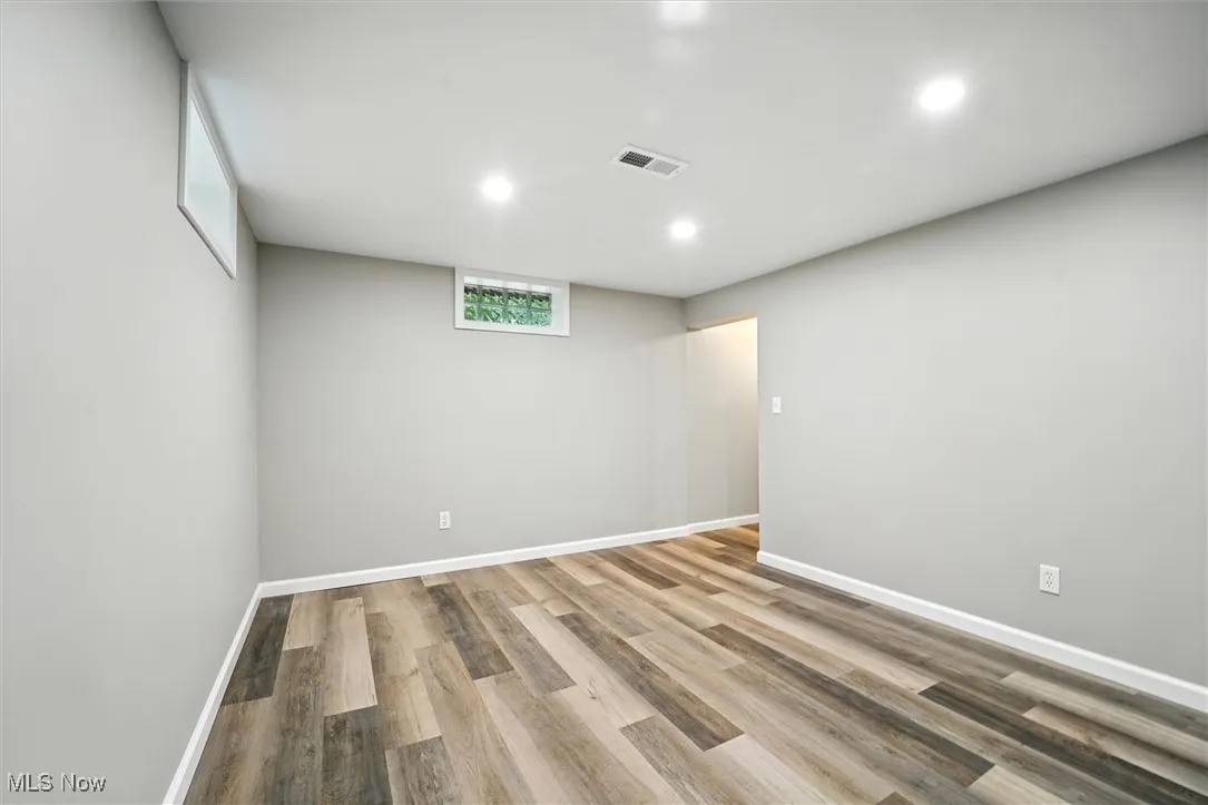 Below grade area featuring wood finished floors and recessed lighting