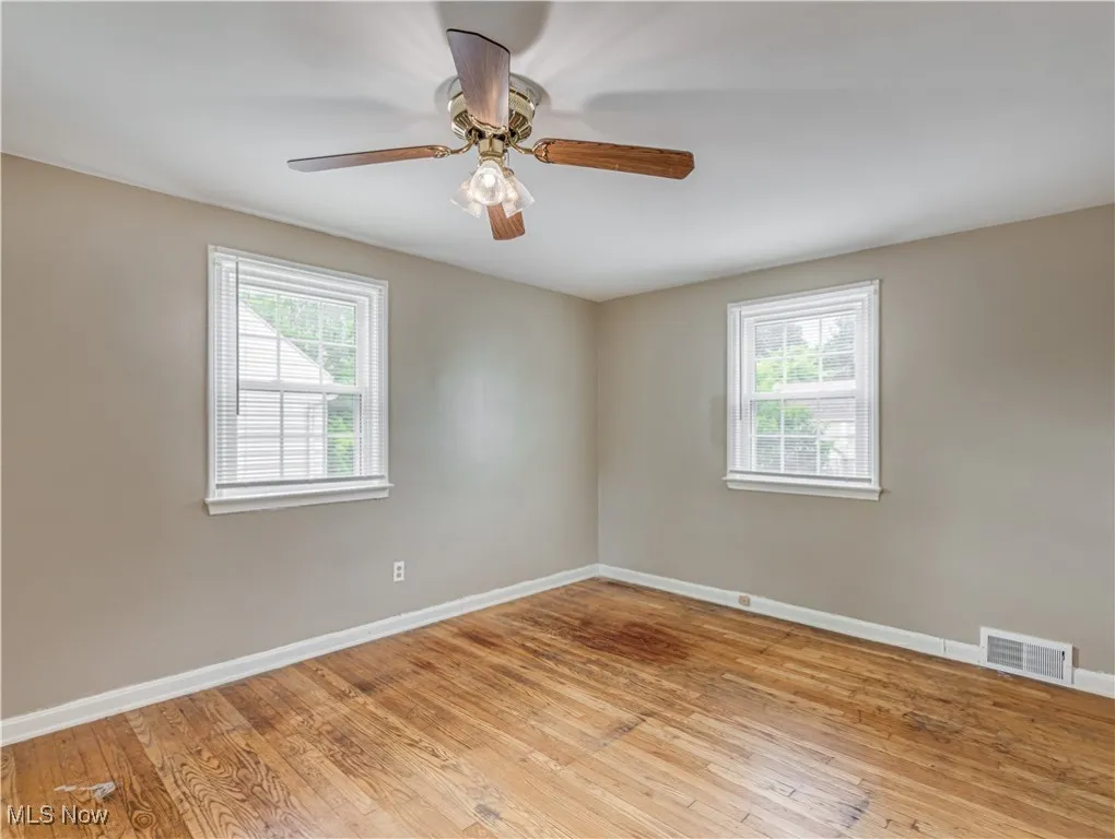 Bedroom with light wood-type flooring, plenty of natural light, and ceiling fan