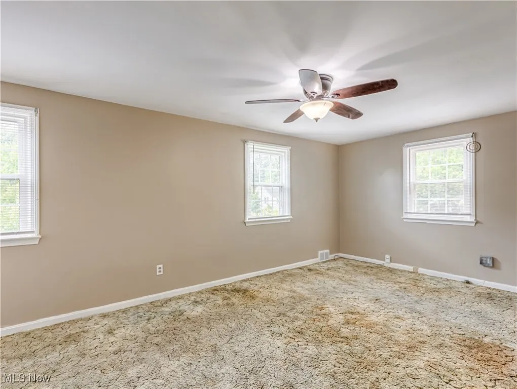 Carpeted bedroom with baseboards and ceiling fan