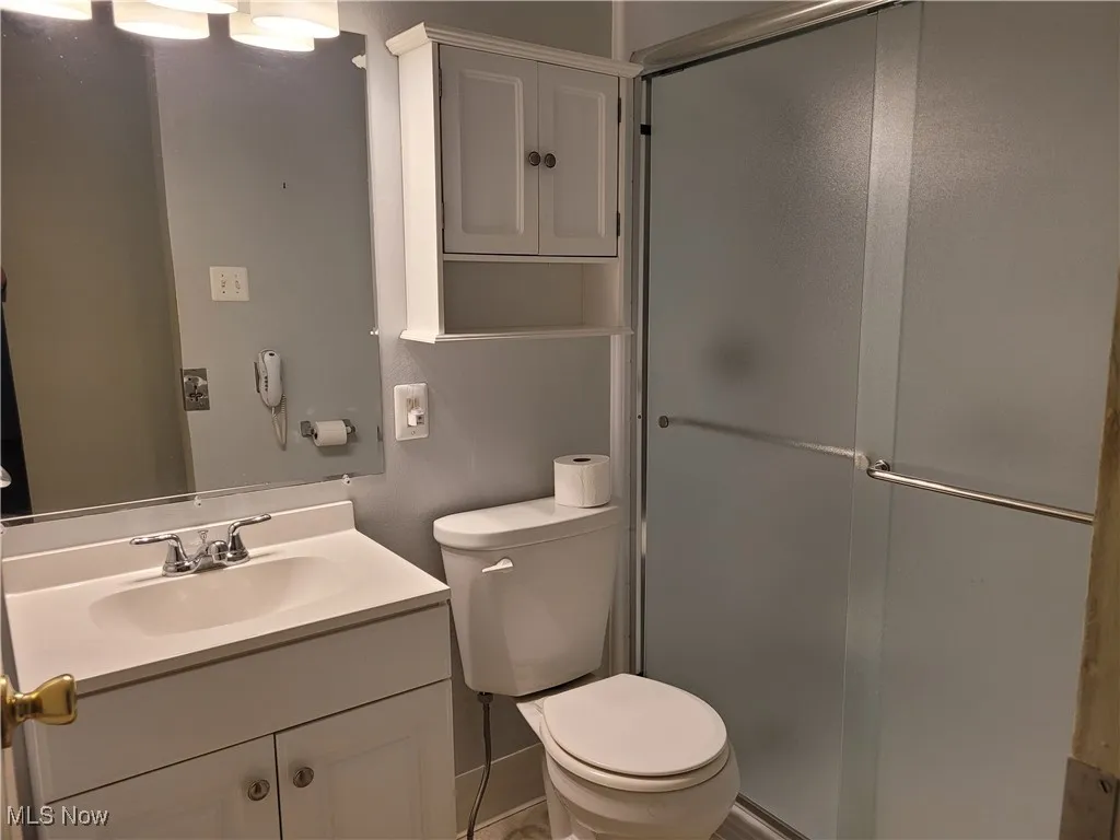Bathroom featuring vanity and a stall shower