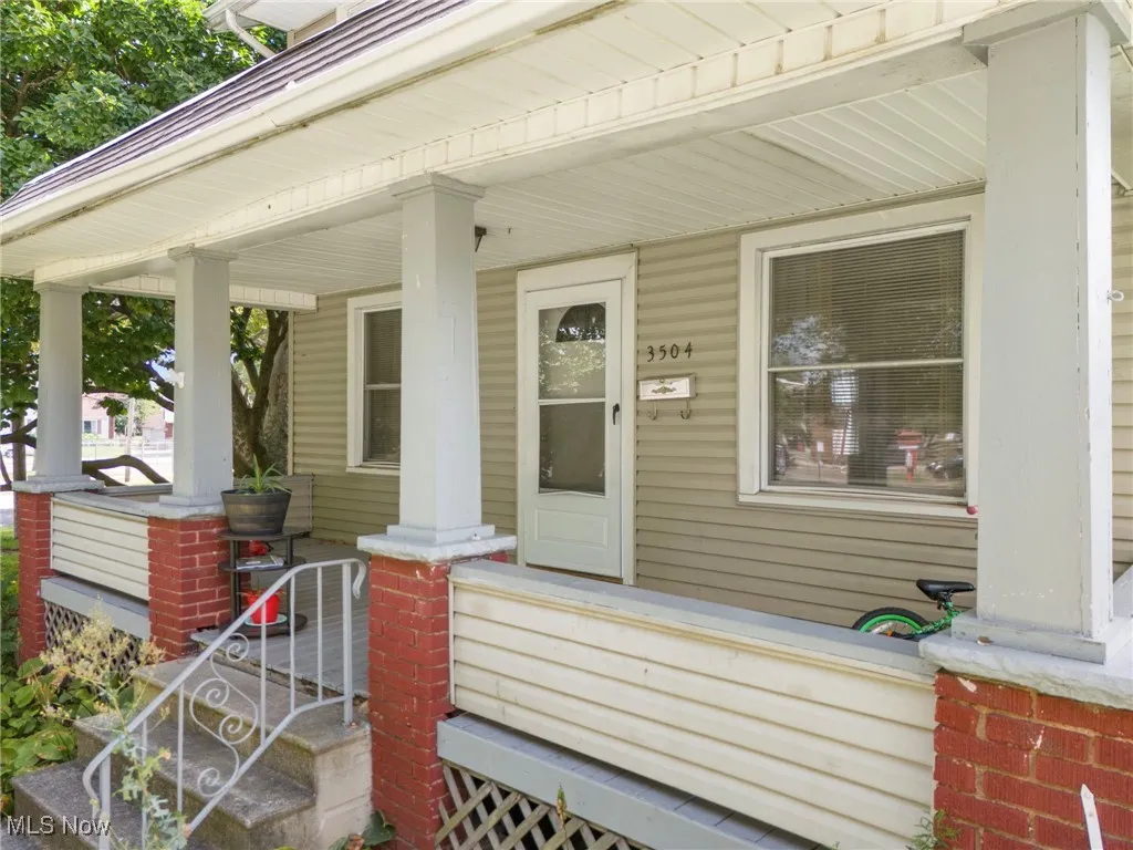 View of exterior entry with a porch